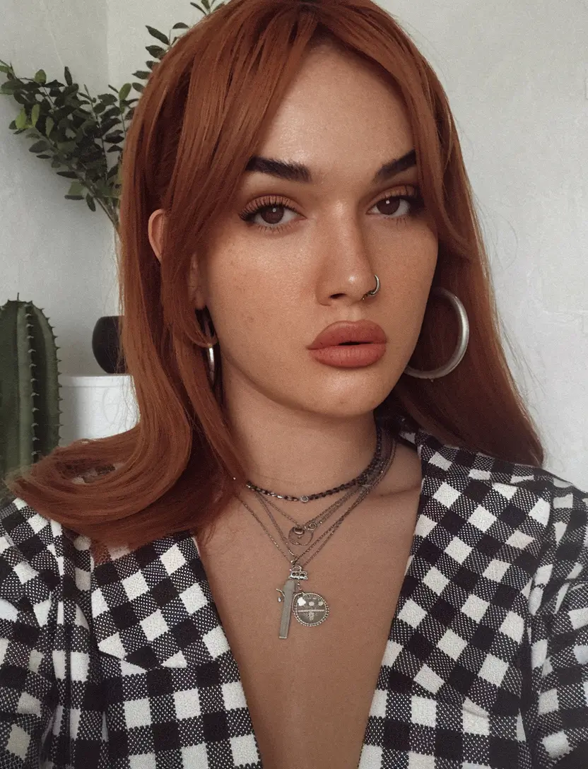 fall hair color for brown skin 2025 Copper Layers With a Bold Flip