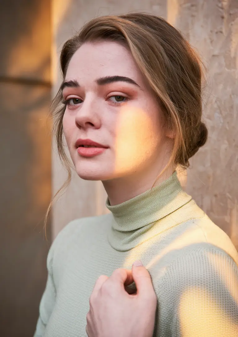 Best Fall Hair Colors Trends 2025 for Cool Skin – Mushroom-Beige Low Bun with Soft Tendrils