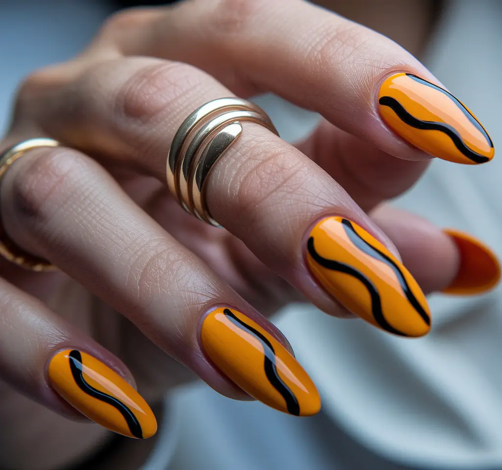 Fall 2025 Nail Color Ideas for Women Over 50 – Tangerine Almond with Ink Waves
