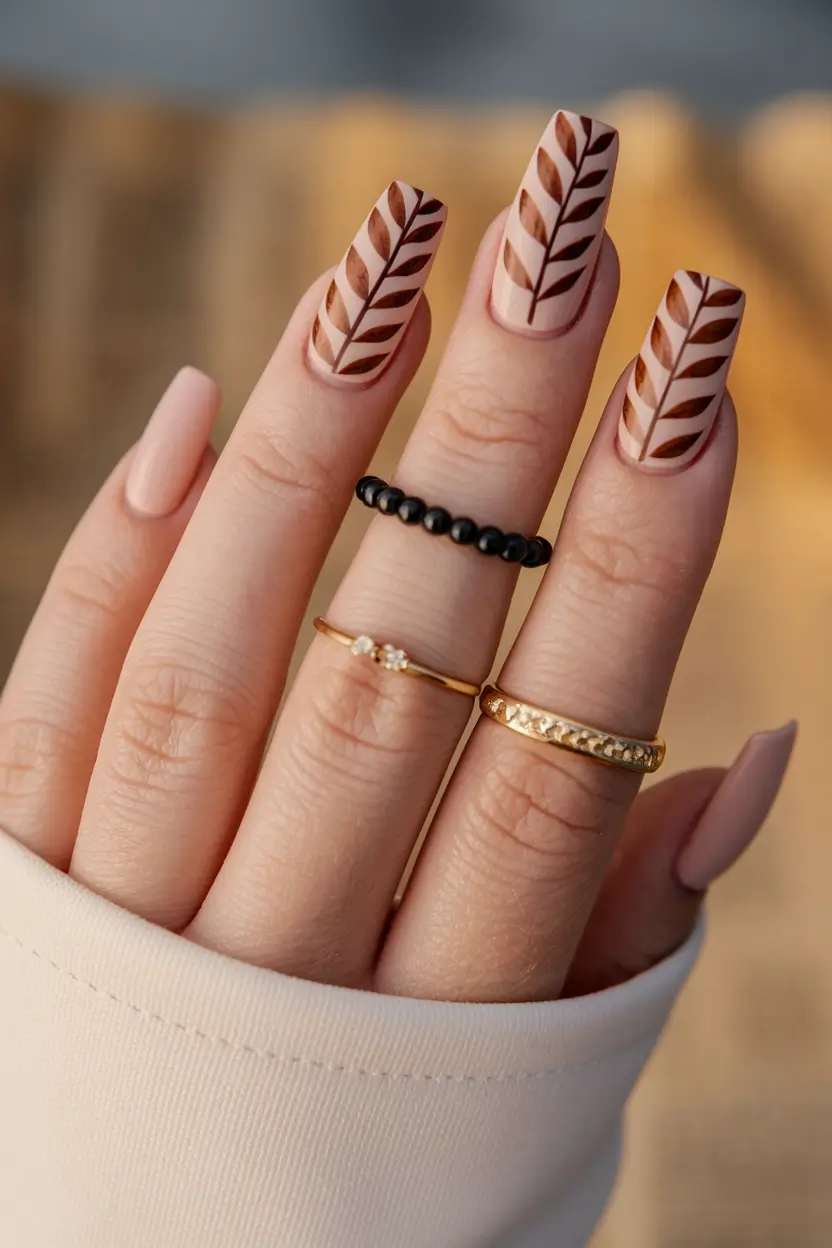 popular fall nail colors 2025 Graphic Leaf Motifs in Brown