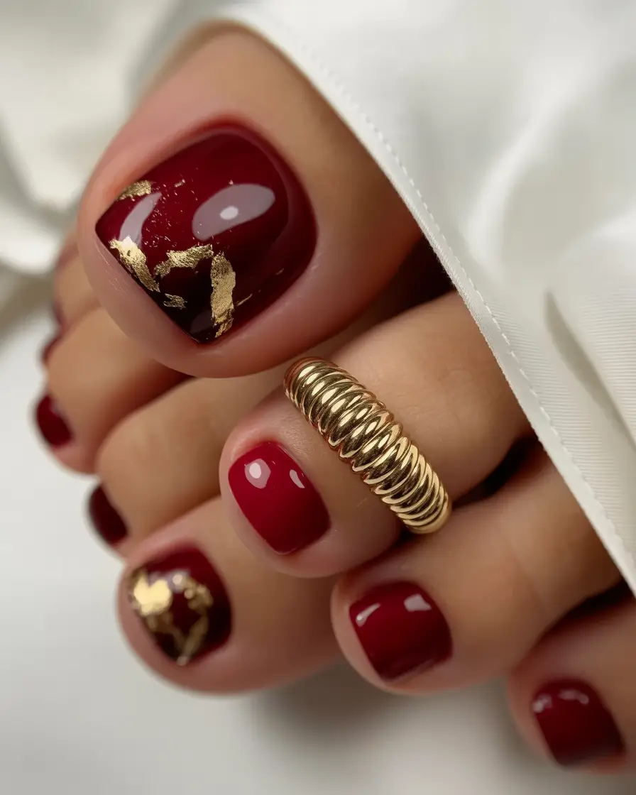 toe nail designs 2026 Deep Red With Gilded Accents