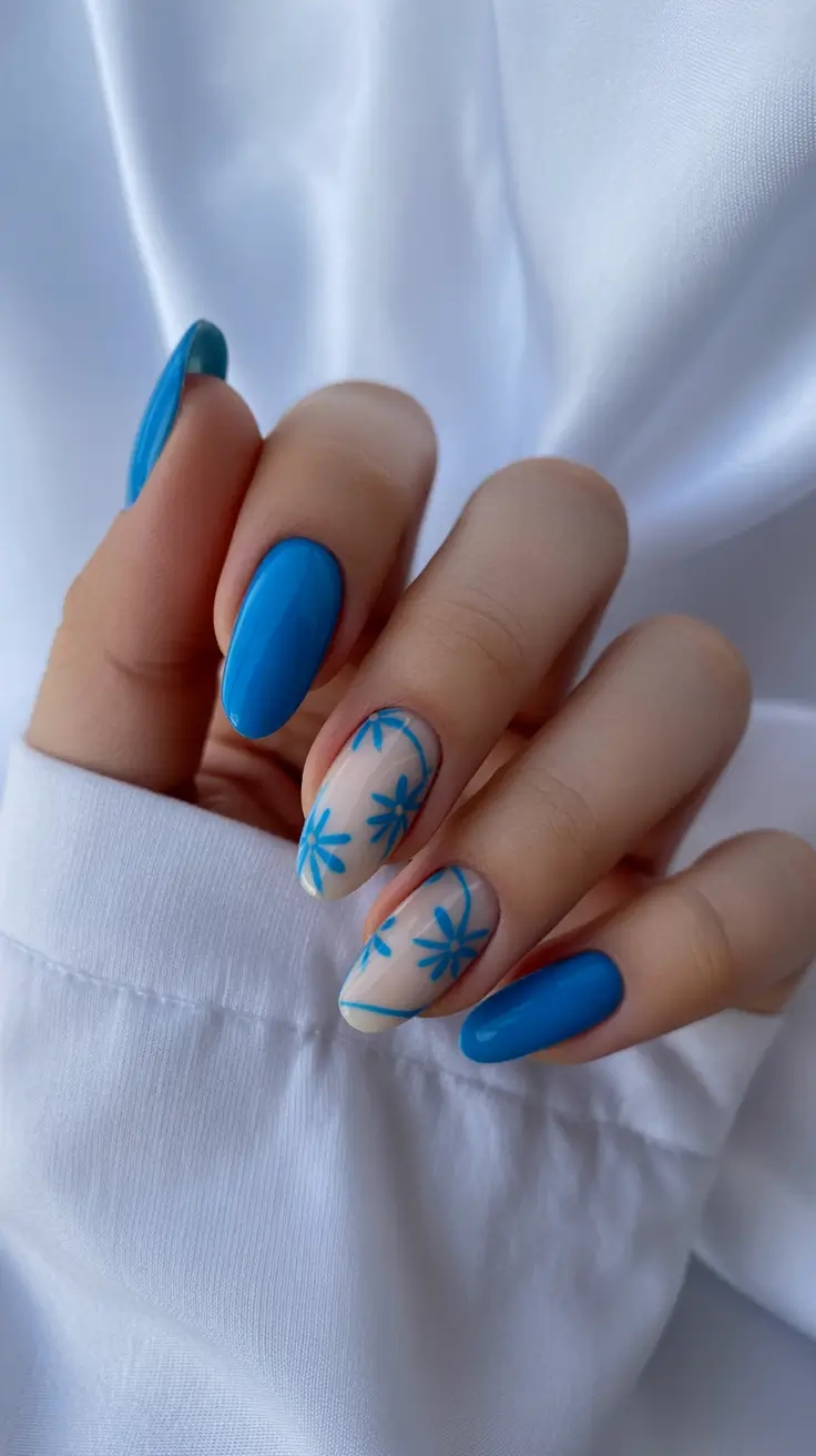 bright spring nails 2026 Sky-Blue Blossoms on Almond Silhouettes
