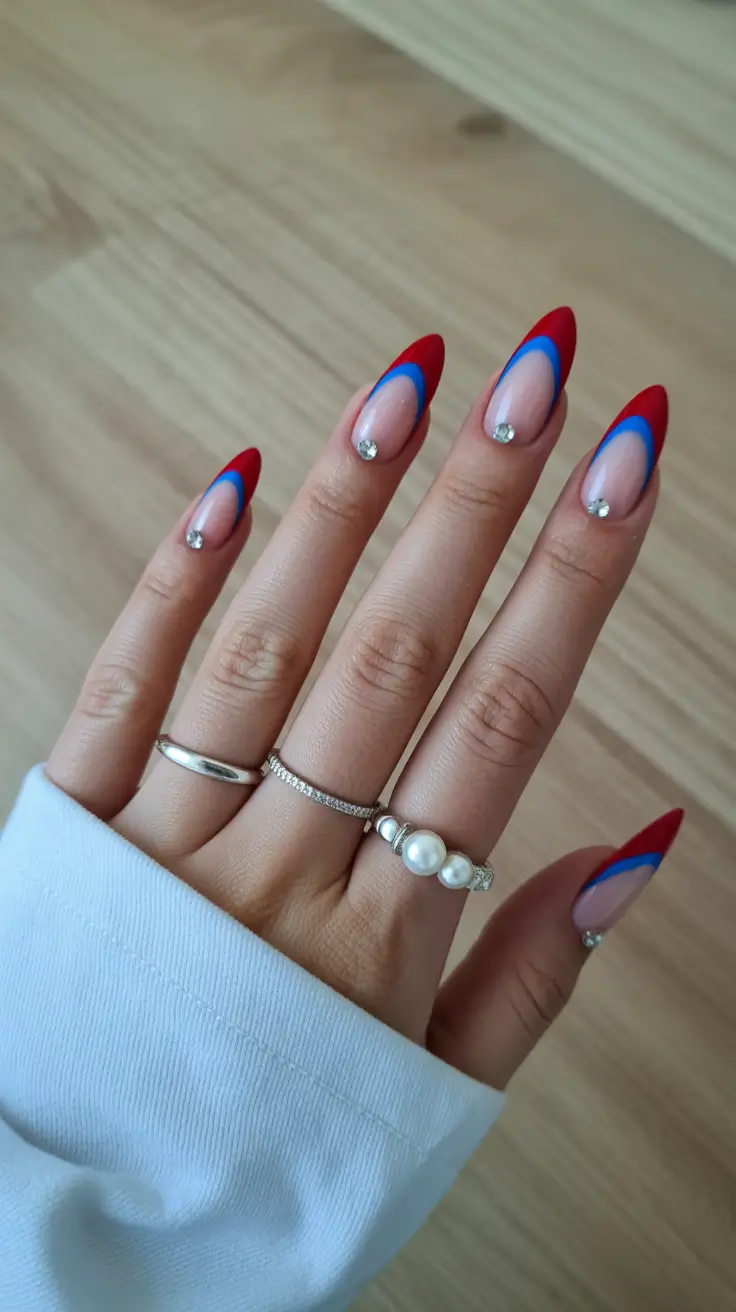 spring almond nails 2026 Red and blue almond nails with crystal detail