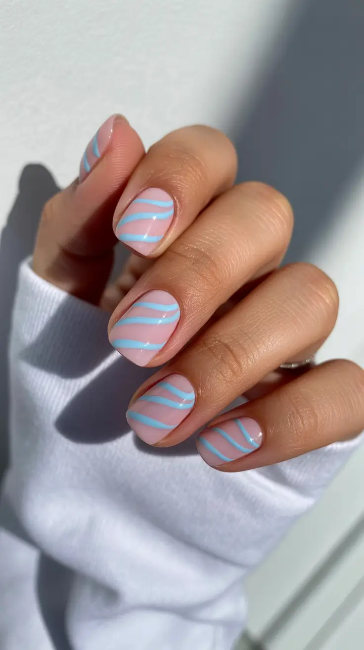 best spring nails simple 2026 Soft Blue Swirl Nails for a Minimal Spring Aesthetic