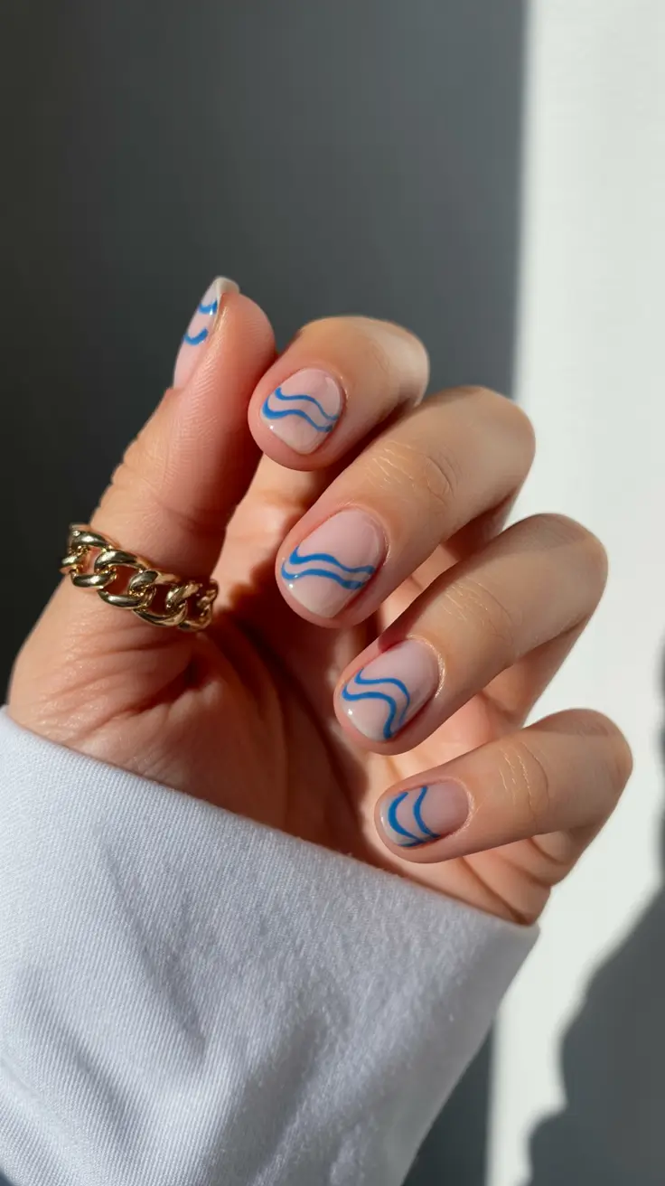 minimalist short spring nails 2026 Minimal Nude Base with Blue Wave Lines