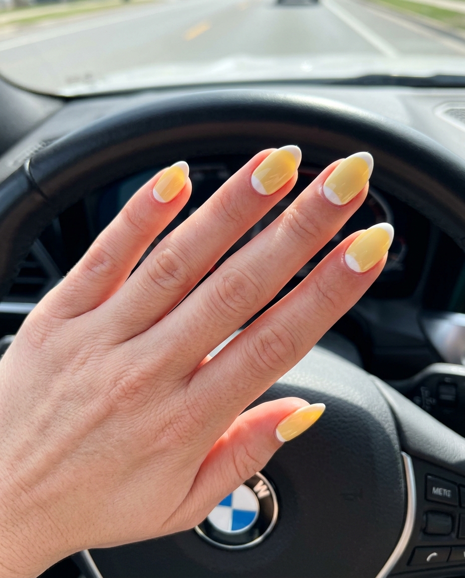Almond summer nails 2026 for fair skin: Butter yellow reverse French almond twist for chic casual looks.