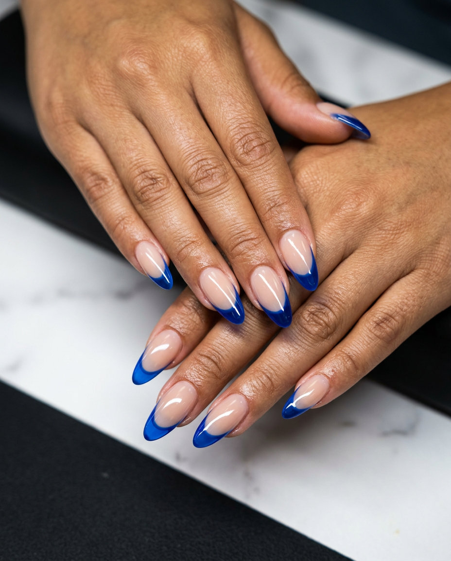 Playful cobalt blue jelly French tip nails for June 2026, vacation style. Medium nails with translucent blue tips.