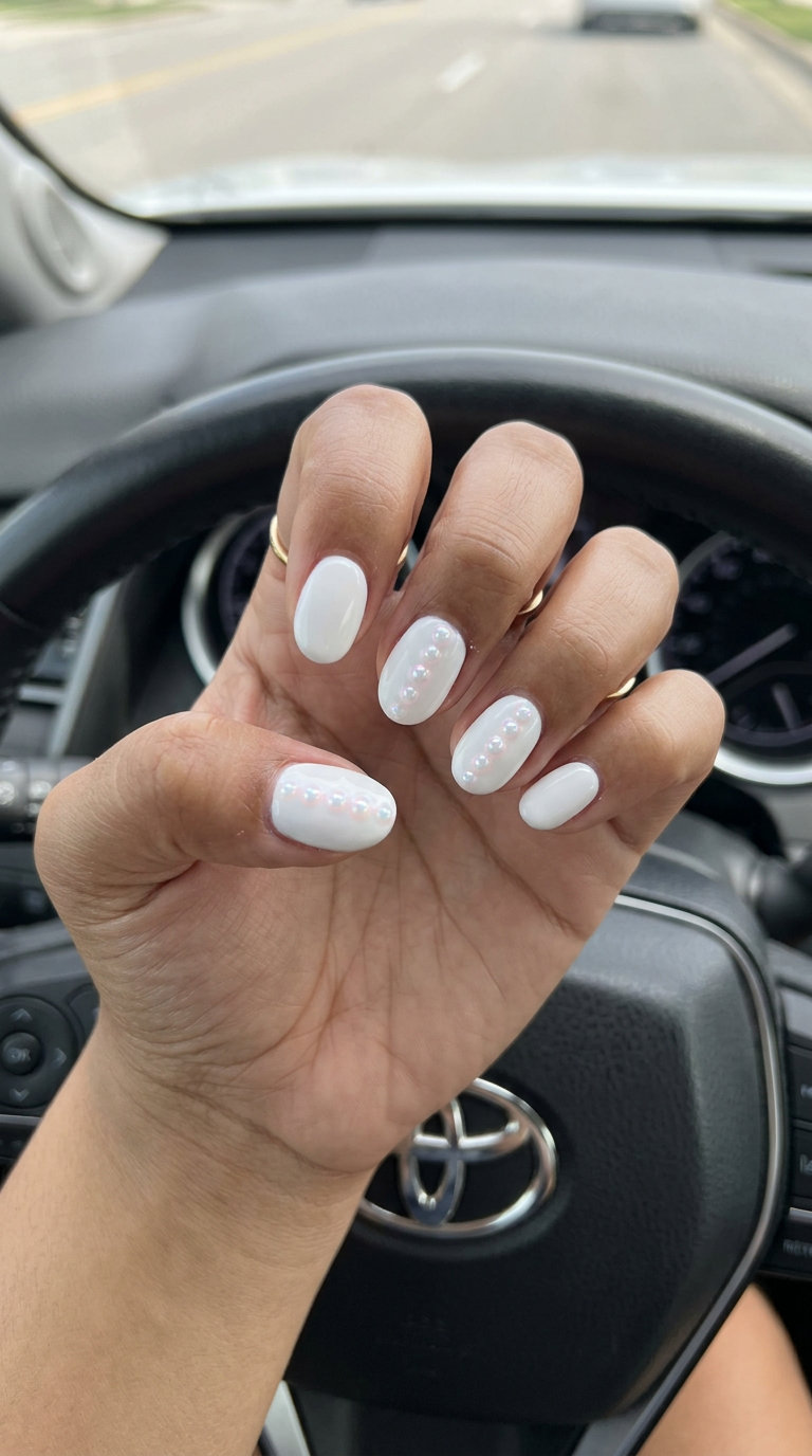 Glistening Pearl Dots nails for June 2026 summer trends: bright white with iridescent pearl accents.