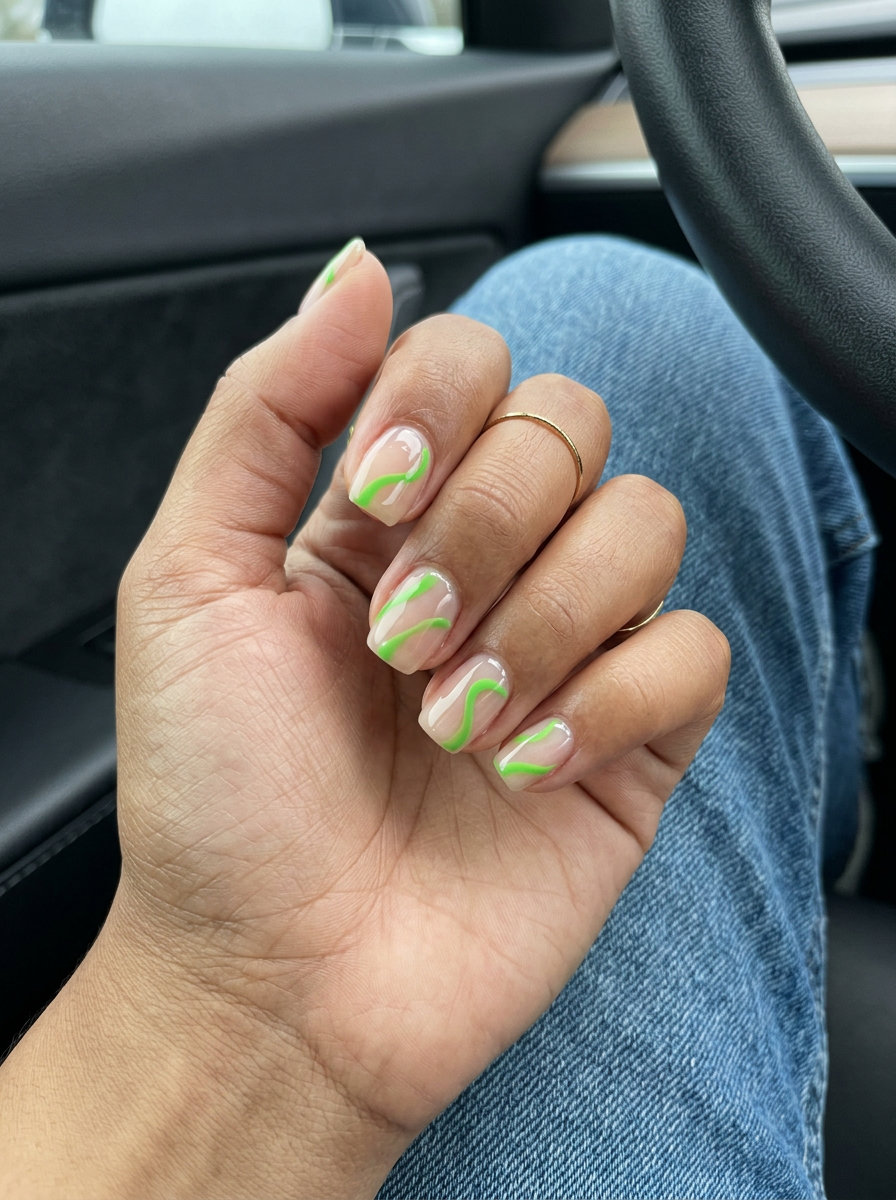 Dynamic lime green line nails for June 2026, artistic casual style. Short square nails with abstract green lines.