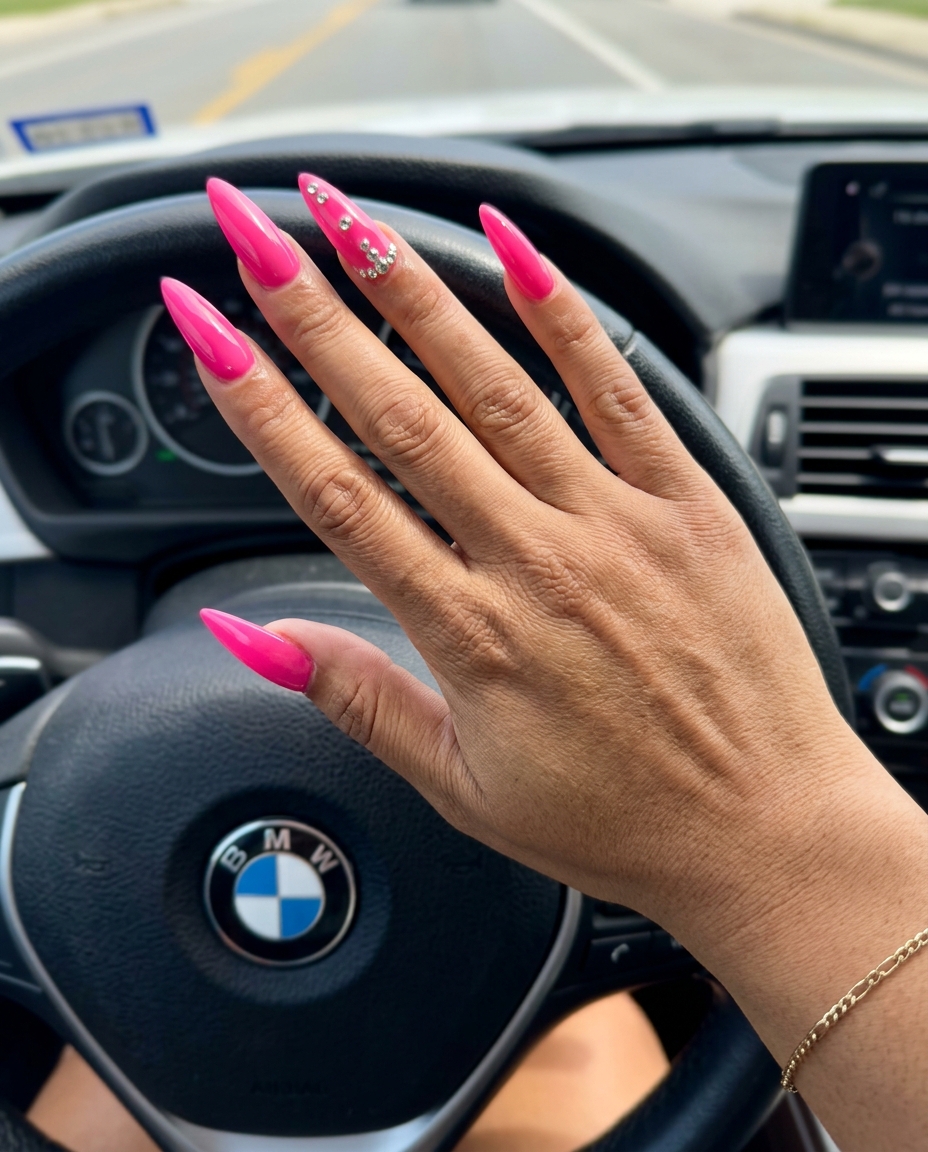 Hot pink glossy stiletto nails with rhinestones for stiletto summer nails 2026. Glamorous date night look.