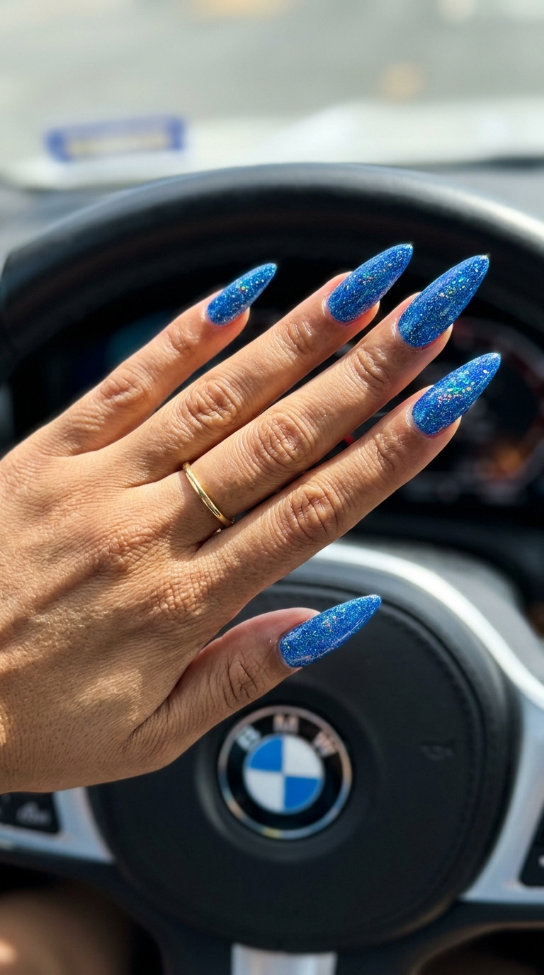 Cosmic Blue Stiletto Sparkle Nails 2026 Cosmic blue stiletto sparkle nails for party, night out, or concert. Edgy and dazzling summer colorful nails designs 2026.