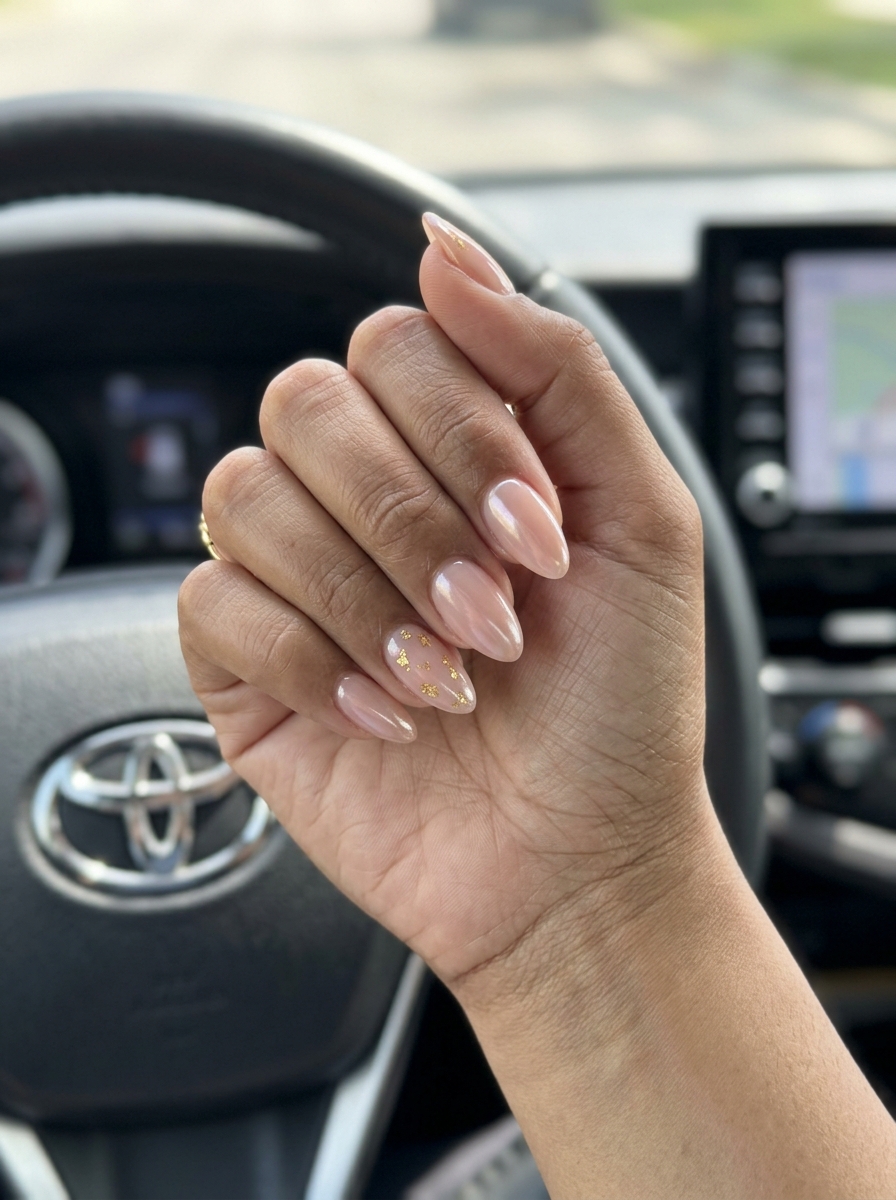 Chic Glazed Nails 2026 | Summer Colorful Designs Sheer nude pink glazed nails with gold foil flakes for summer colorful nails designs 2026. Elegant almond shape.