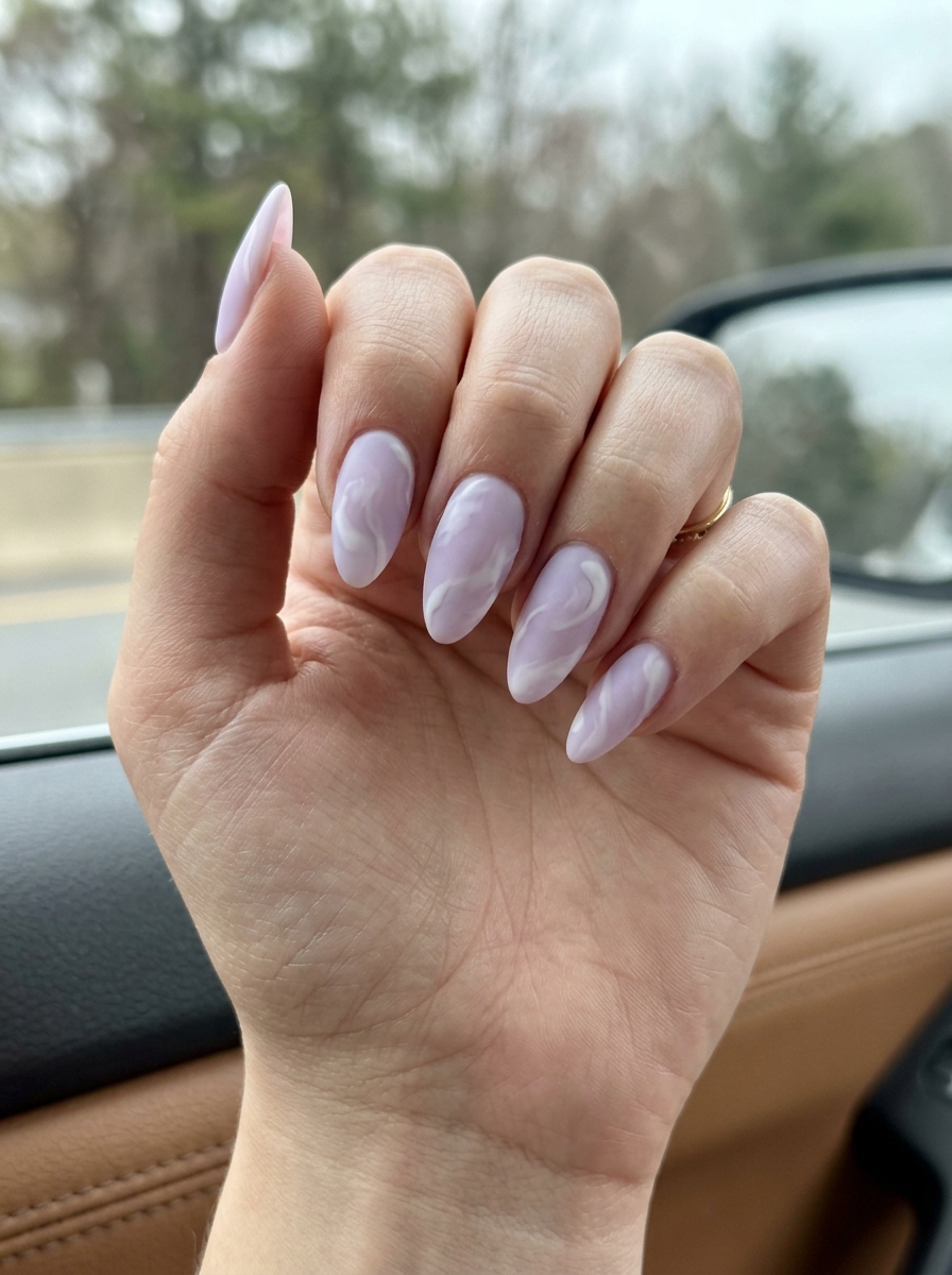 Dreamy Lavender Swirls 2026 | Ethereal Nails Milky lavender nails with white abstract swirls and satin matte finish for summer colorful nails designs 2026.