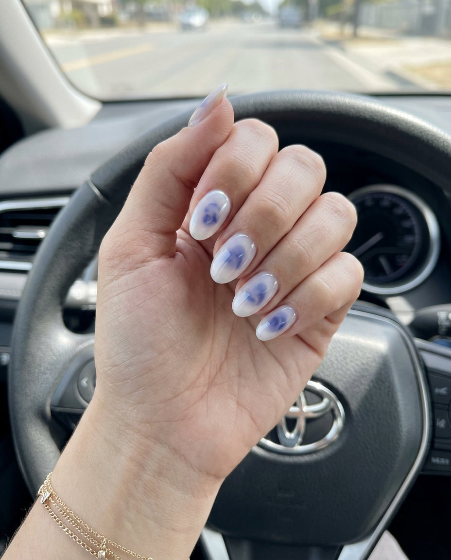 Milky white oval nails with translucent blueberry jelly elements for a romantic look.