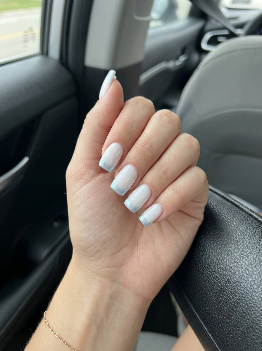 Arctic Shimmer French Nails 2026: Cool Festival Style Arctic shimmer French nails for summer vibes 2026. Milky white with icy blue shimmer tips for festivals.