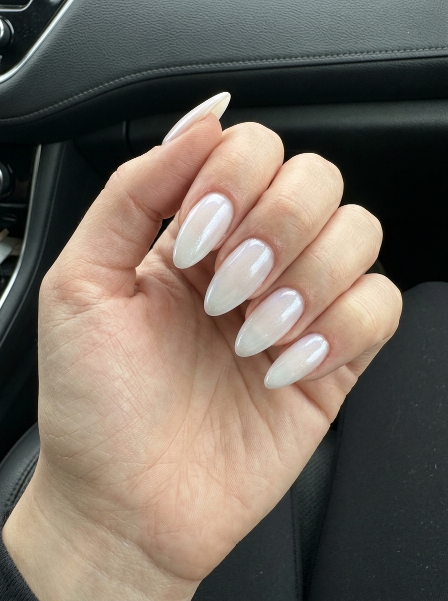 Milky white jelly almond nails with subtle shimmer, a romantic choice for summer wedding nails 2026.