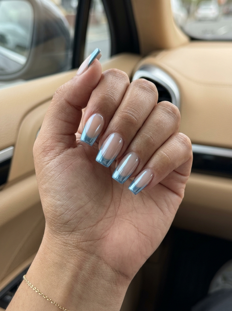 Trending Summer Nails 2026: Edgy Metallic Blue Trending summer nails 2026: Metallic sky blue French square nails for a futuristic festival or party look.