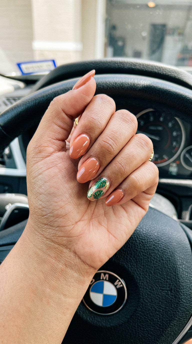 Island Leaf Nude nails: warm nude with emerald green & gold foil for vacation nails summer 2026.