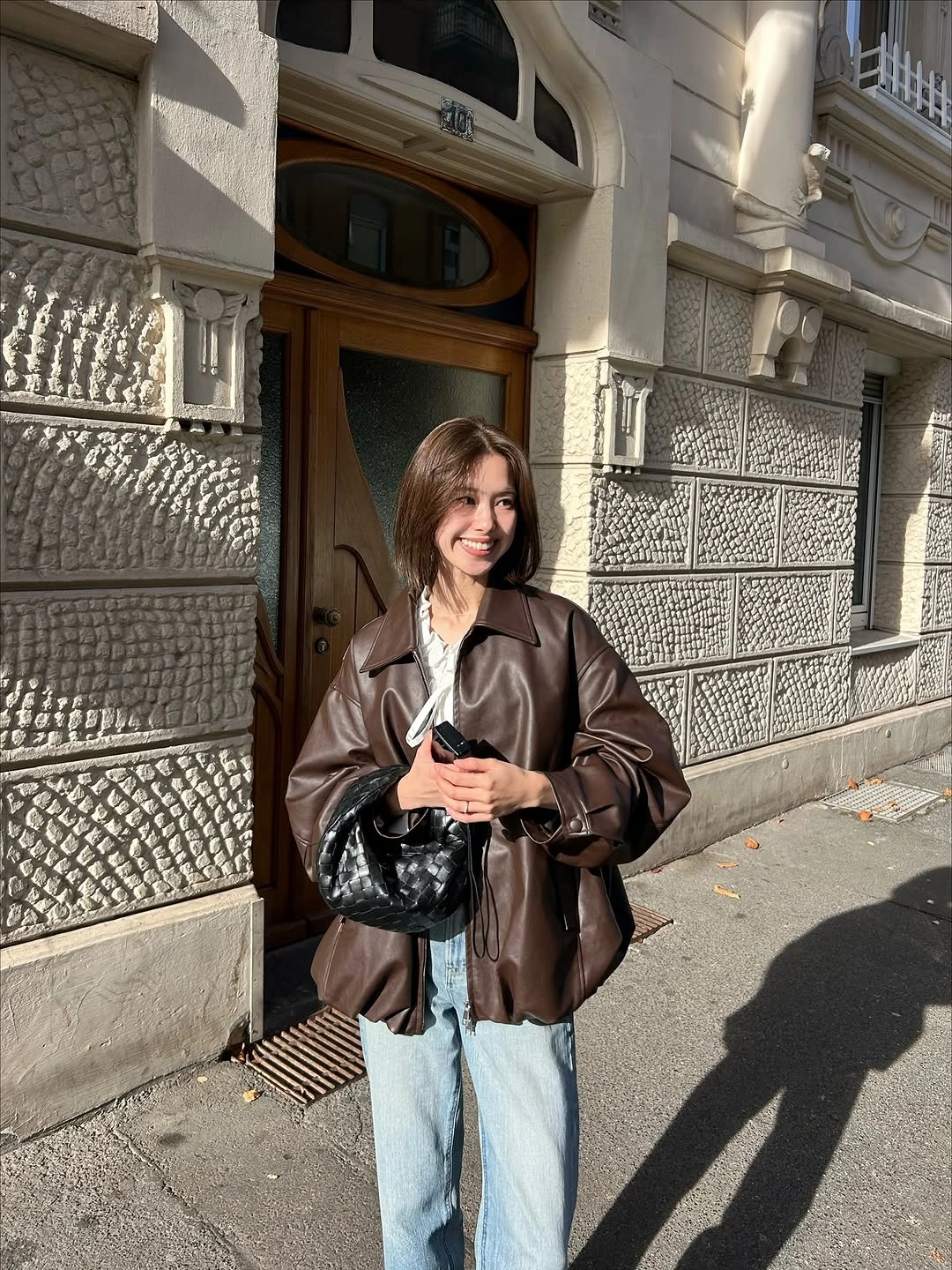 fall going out outfits 2026 Chocolate Leather Jacket with Light Denim for Modern Street Style