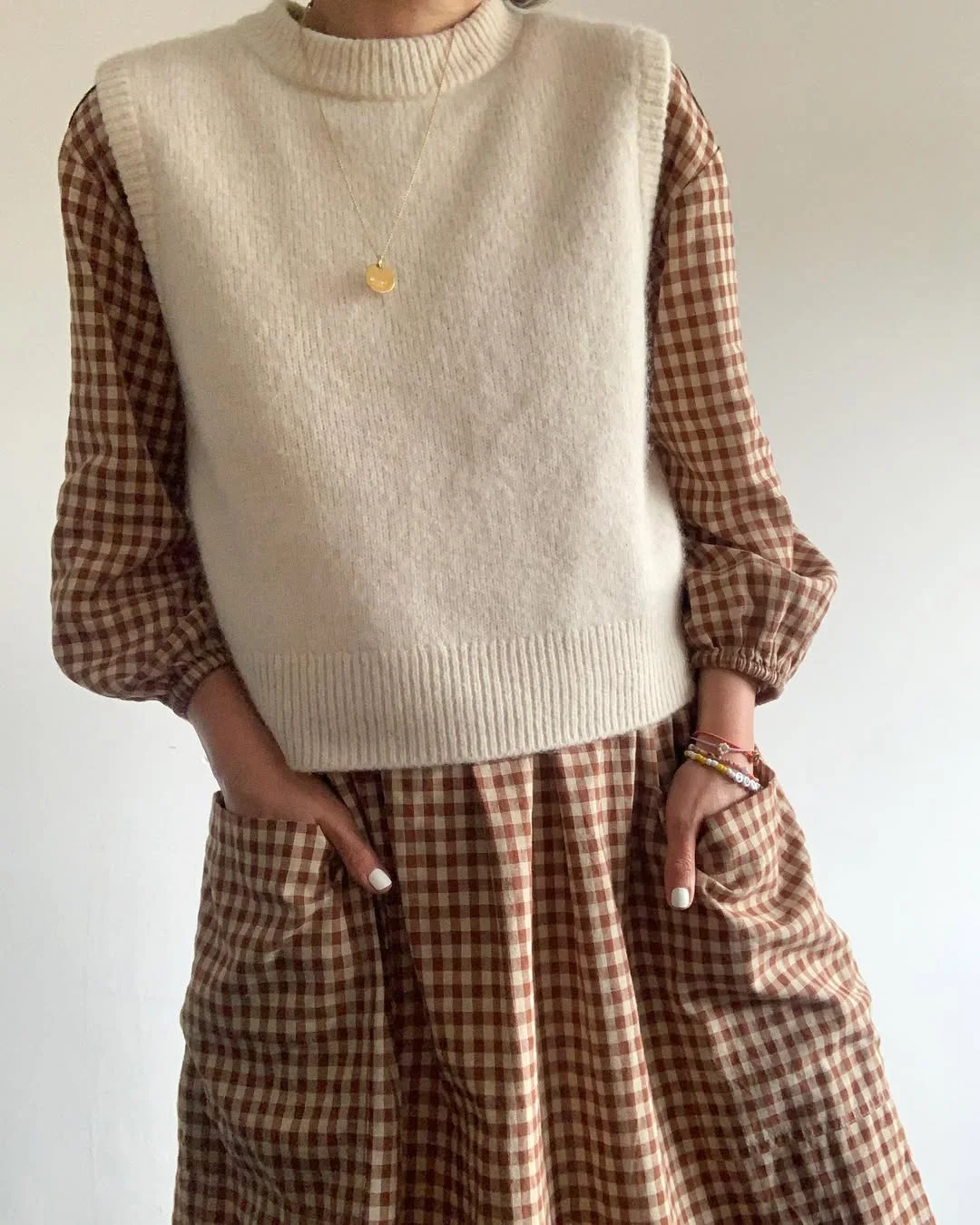 fall outfits with vests 2026 Soft Neutral Knit Vest with a Charming Gingham Dress