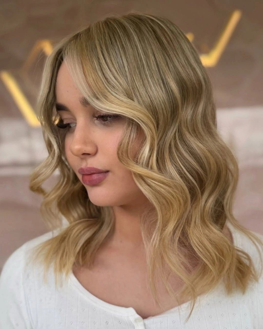body waves hairstyle Face-Framing Blonde Waves With a Soft Side Part