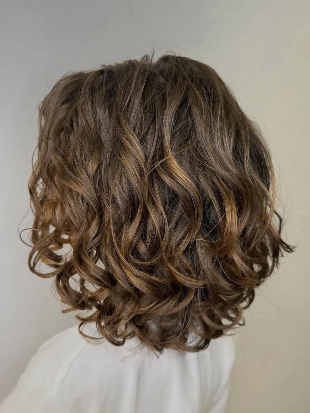 body waves hairstyle Chocolate Brown Waves With Soft Caramel Dimension