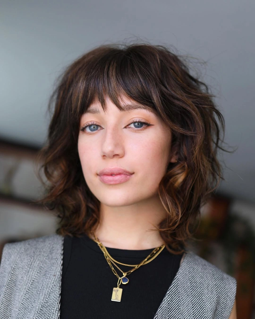 body waves hairstyle French-Inspired Textured Waves With Wispy Bangs