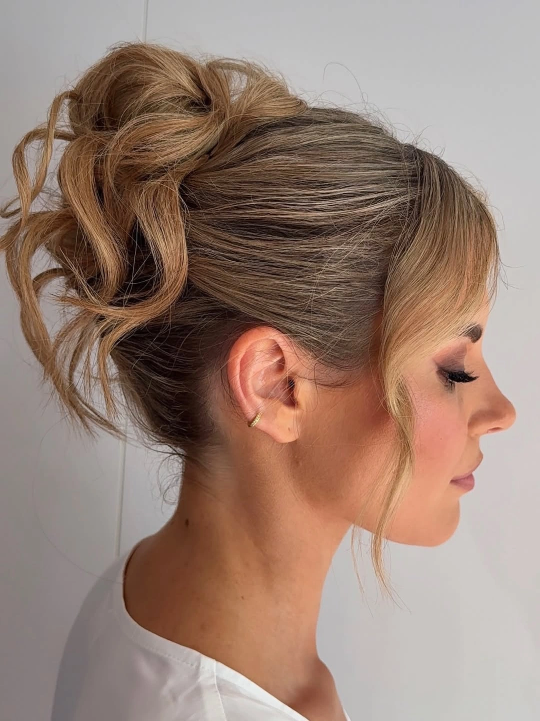 bridesmaid hairstyling Modern High Textured Bun With Soft Face Framing