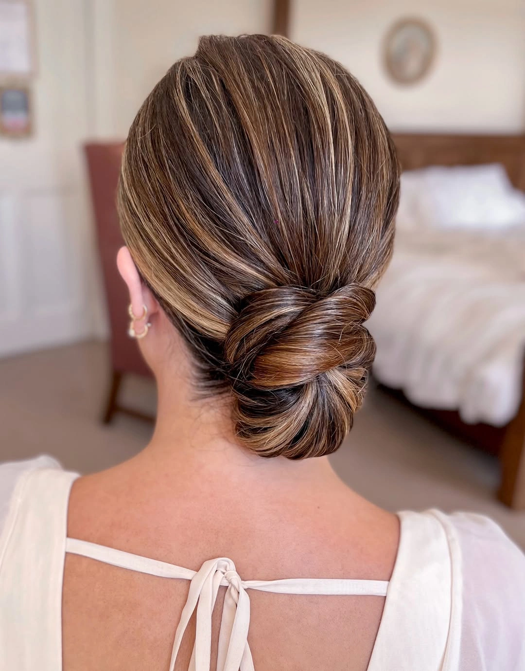 bridesmaid hairstyling Sleek Low Bridal Bun With Timeless Sophistication