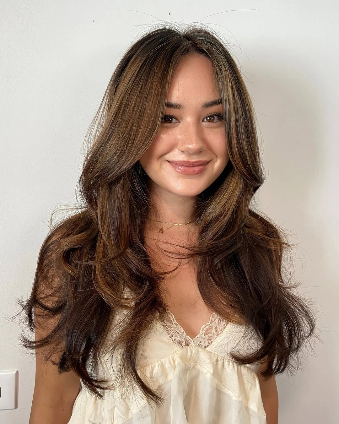 chestnut brown hair color Layered Chestnut Blowout With Warm Highlights