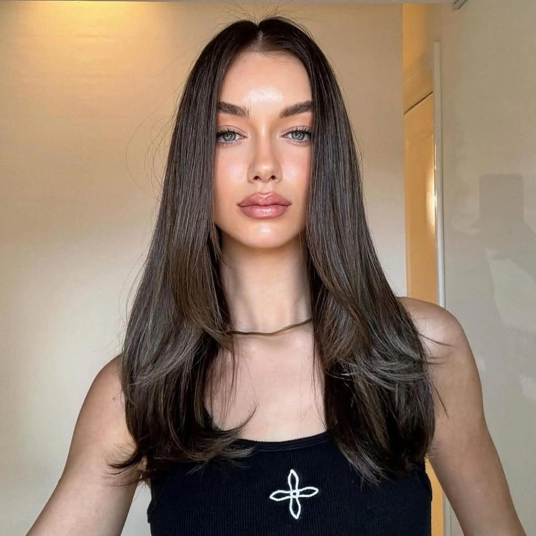 dimensional brunette hair color Smooth Brunette Layers With Clean Center Part