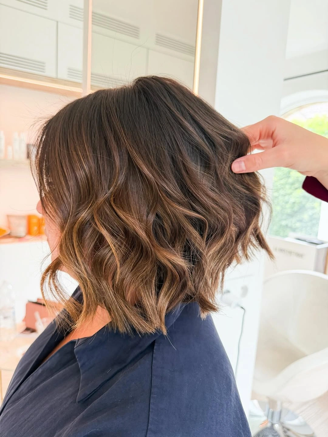 dimensional brunette hair color Short Wavy Brunette Lob With Warm Ends