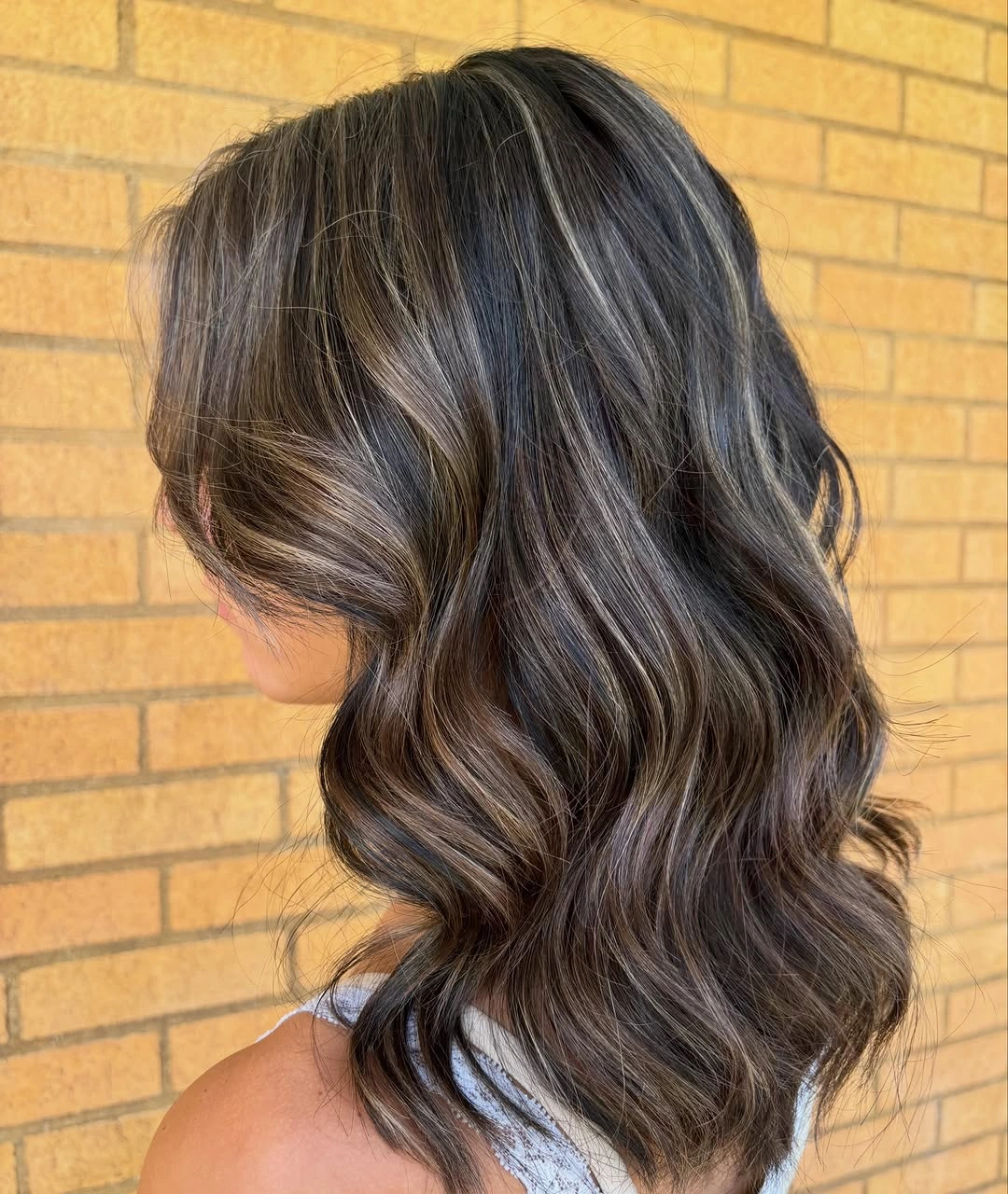 dimensional brunette hair color Ash-Toned Brunette Waves With Ribboned Depth
