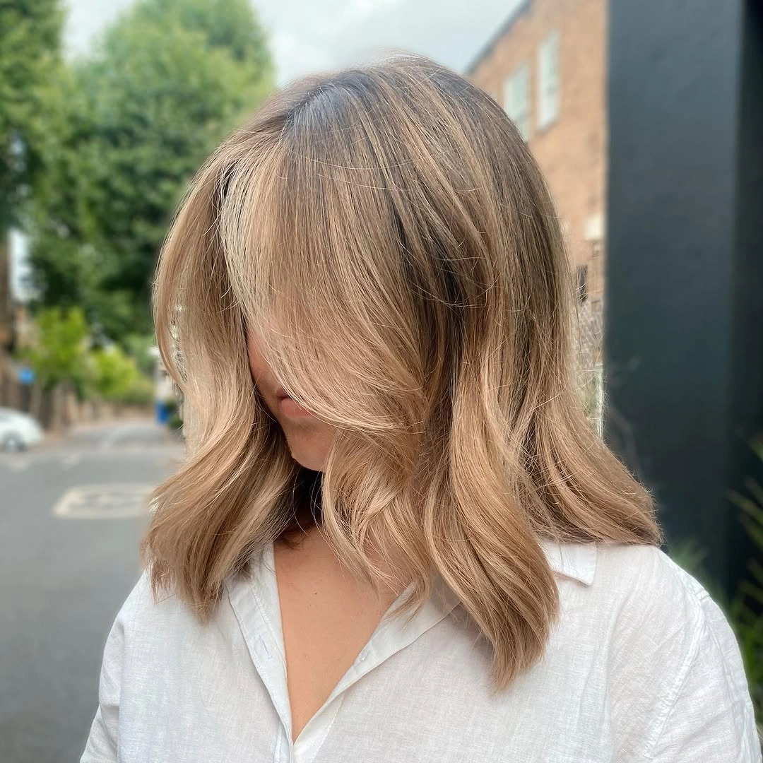 dirty blonde hair color Modern Shoulder-Length Dirty Blonde Lob With Curtain Bangs