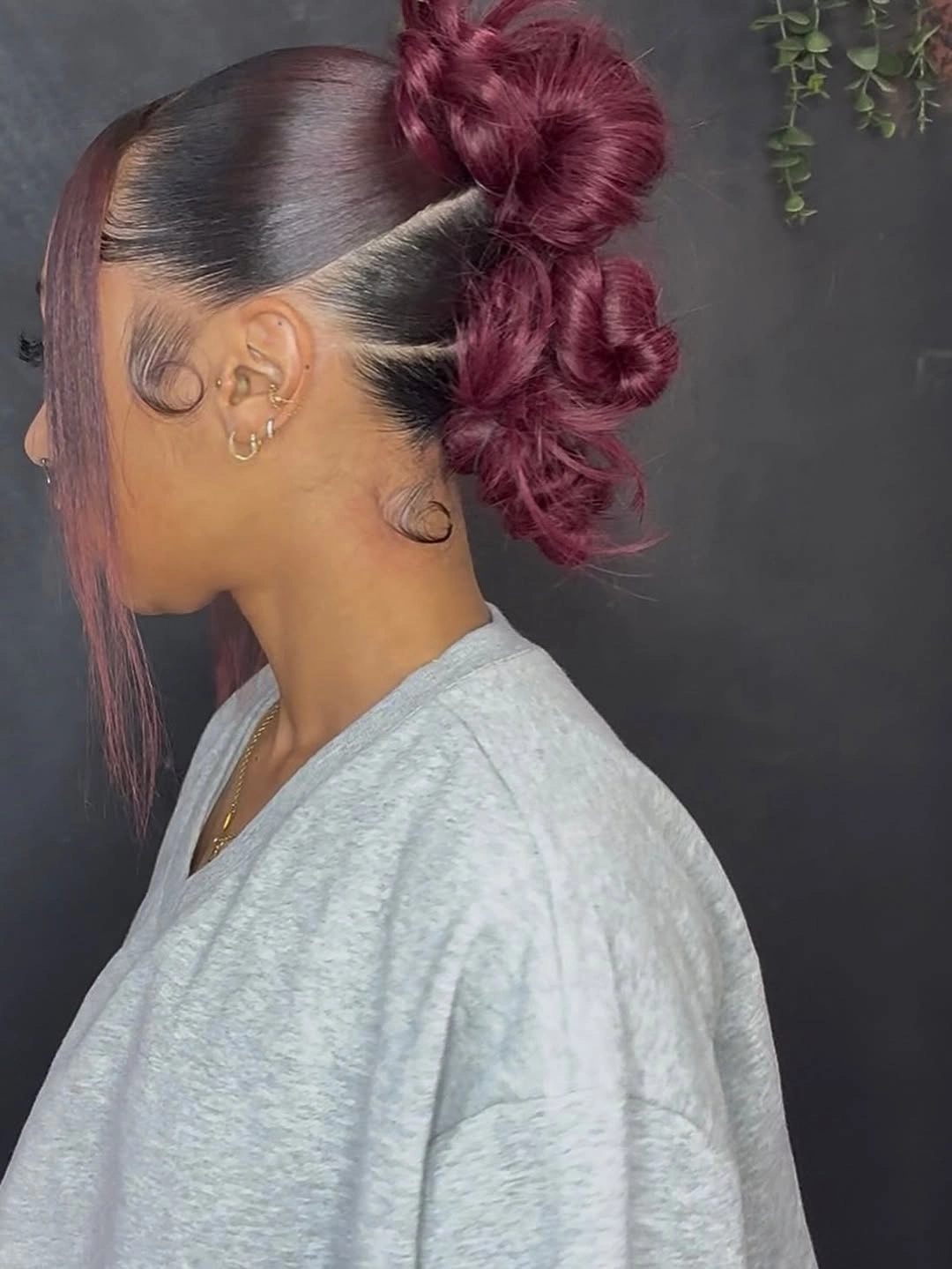 fall hair colors for black women 2026 Deep Burgundy Sleek Updo With Editorial Edge