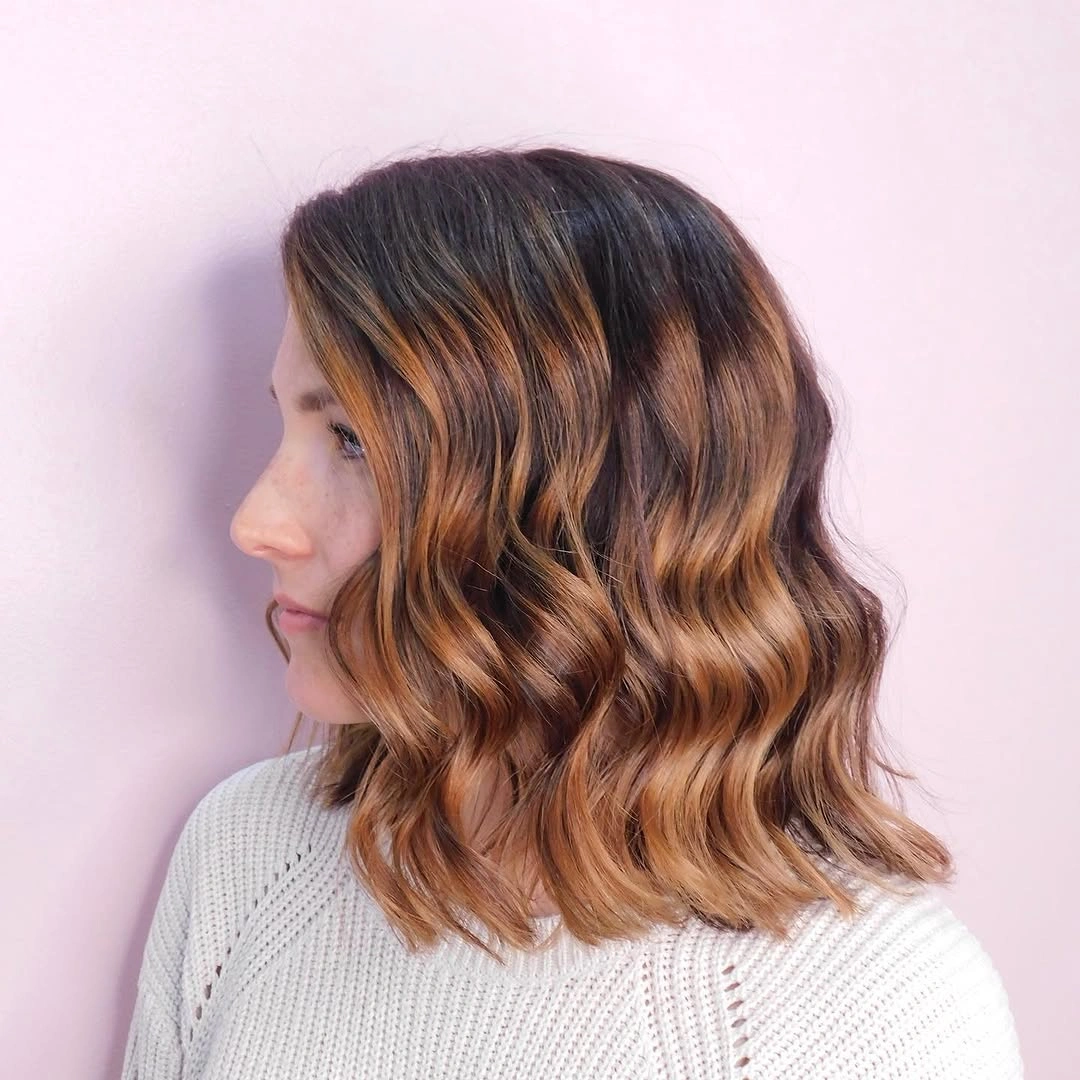 fall haircuts for women 2026 Textured Wavy Lob With Warm Caramel Dimension