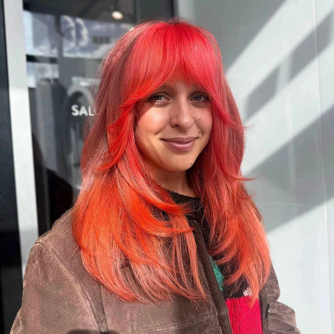 fall hairstyles 2026 Vibrant Coral Shag with Statement Fringe