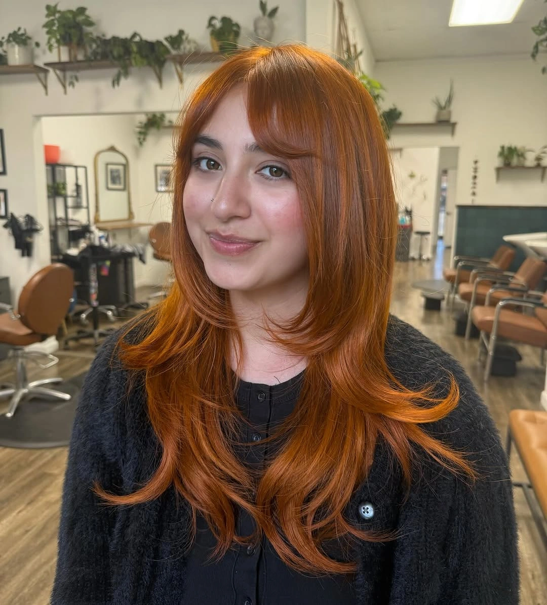 fall hairstyles for long hair 2026 Soft Copper Butterfly Layers With Wispy Bangs