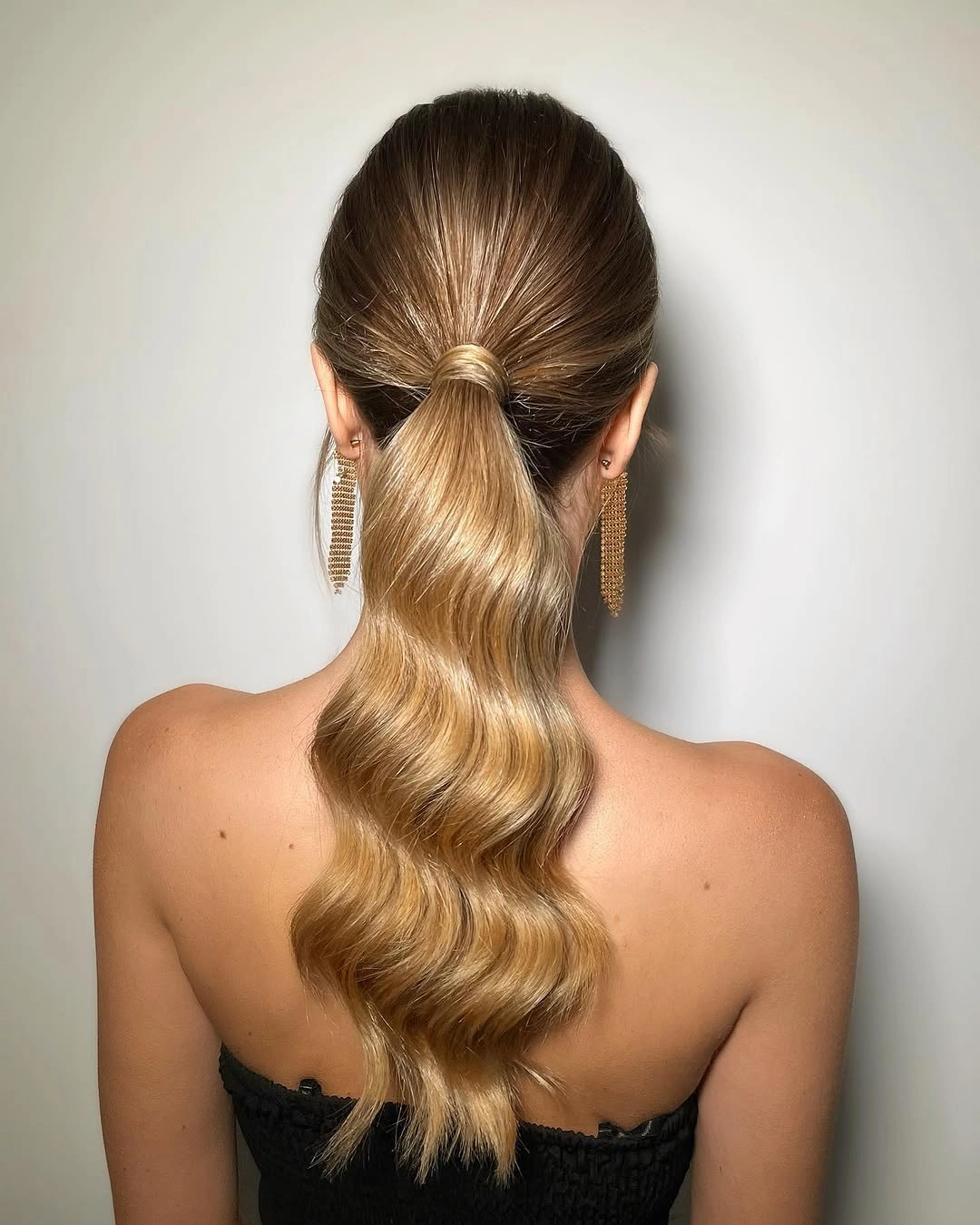 Fall hairstyles for office 2026 Glossy Low Ponytail with Soft Hollywood Waves