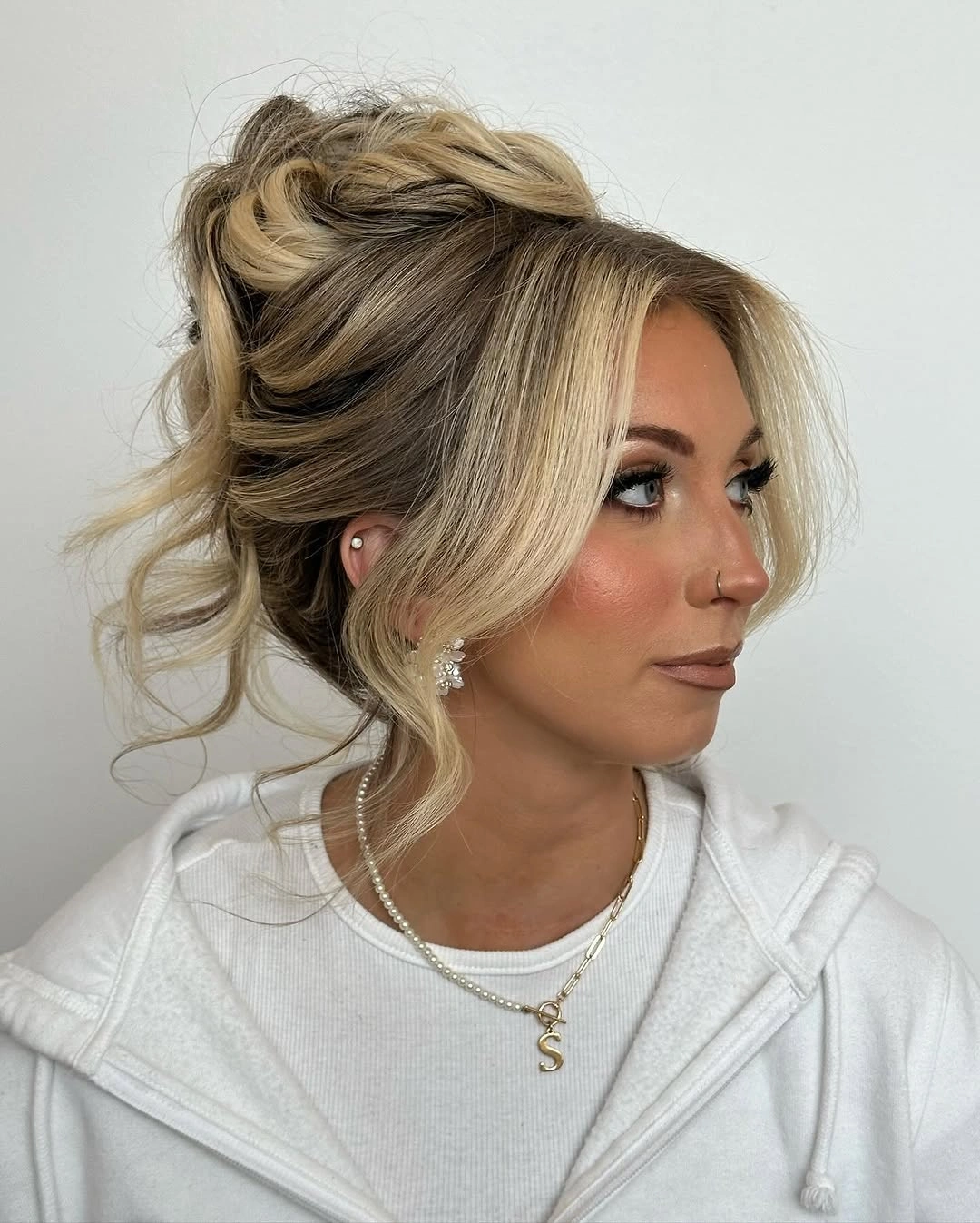 Fall hairstyles for wedding guests 2026 Romantic Textured Blonde Updo with Soft Face-Framing Layers