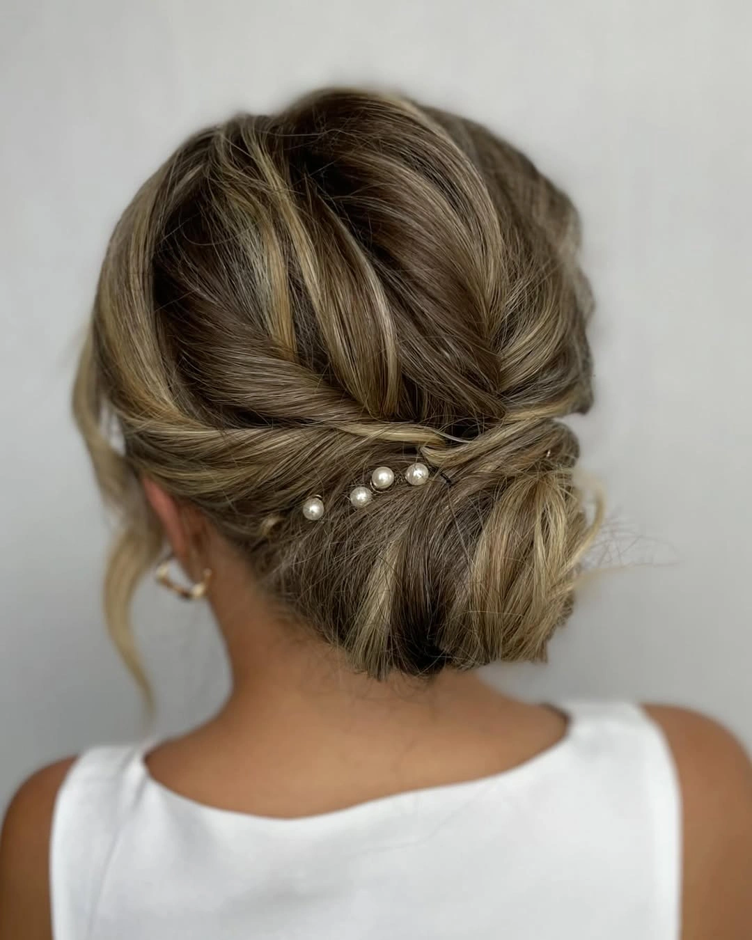 Fall hairstyles for wedding guests 2026 Elegant Twisted Low Bun for Shorter Hair