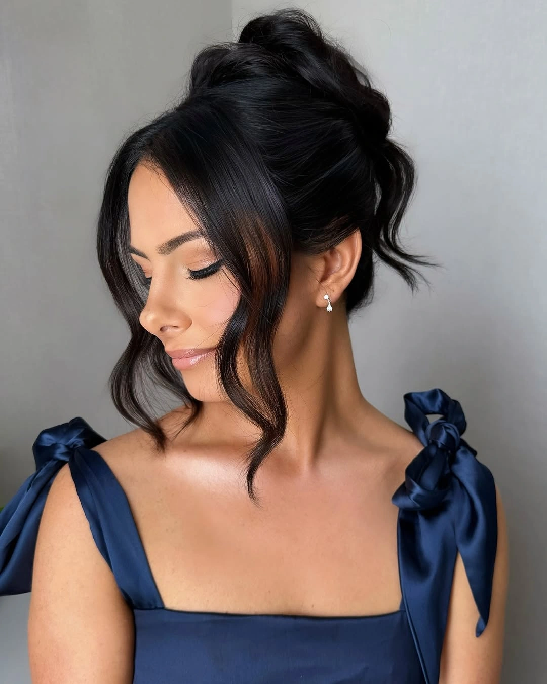 Fall hairstyles for wedding guests 2026 Soft High Bun with Face-Framing Waves