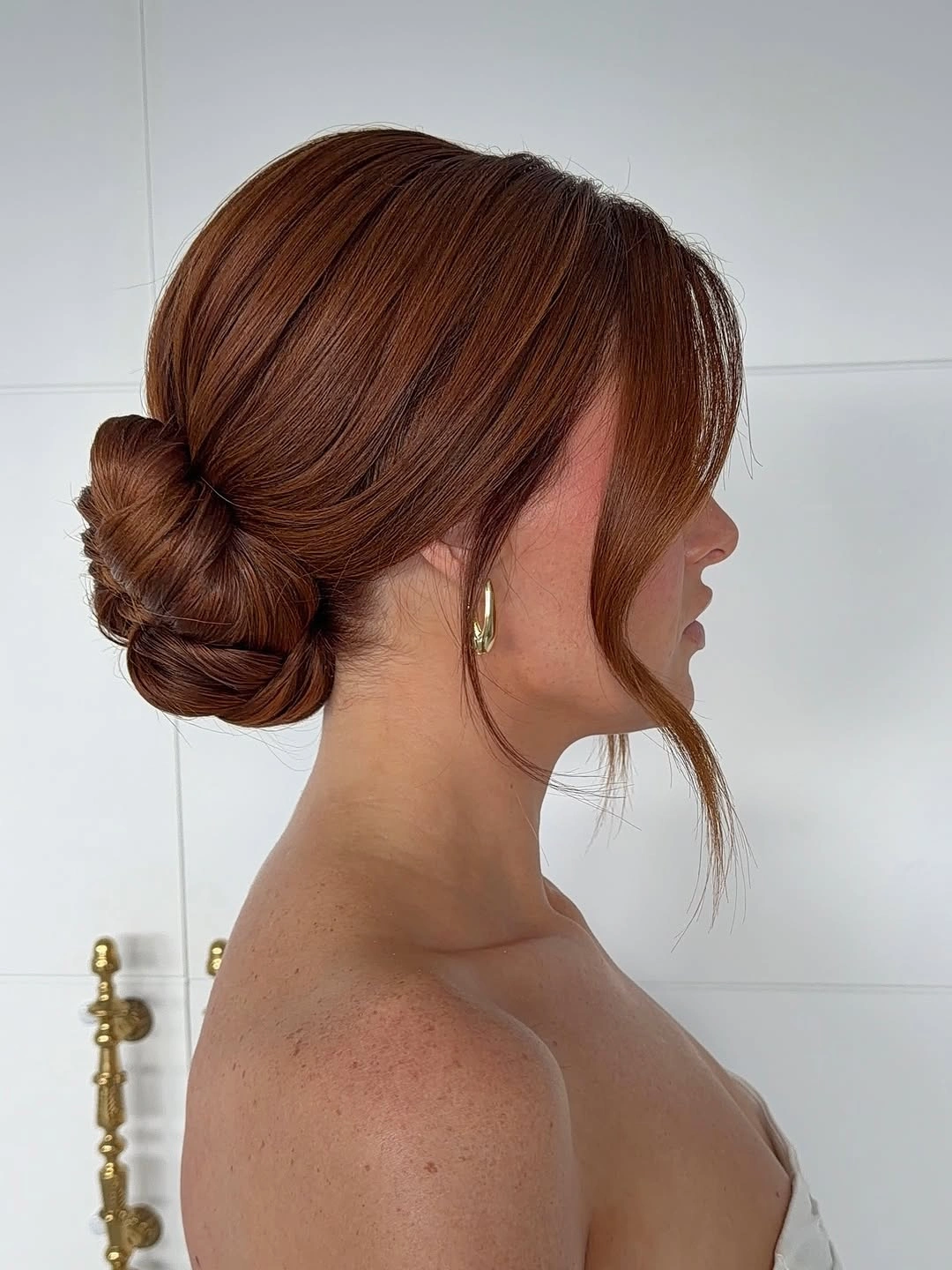 Fall hairstyles for wedding guests 2026 Classic Low Chignon with Soft Face-Framing Layers