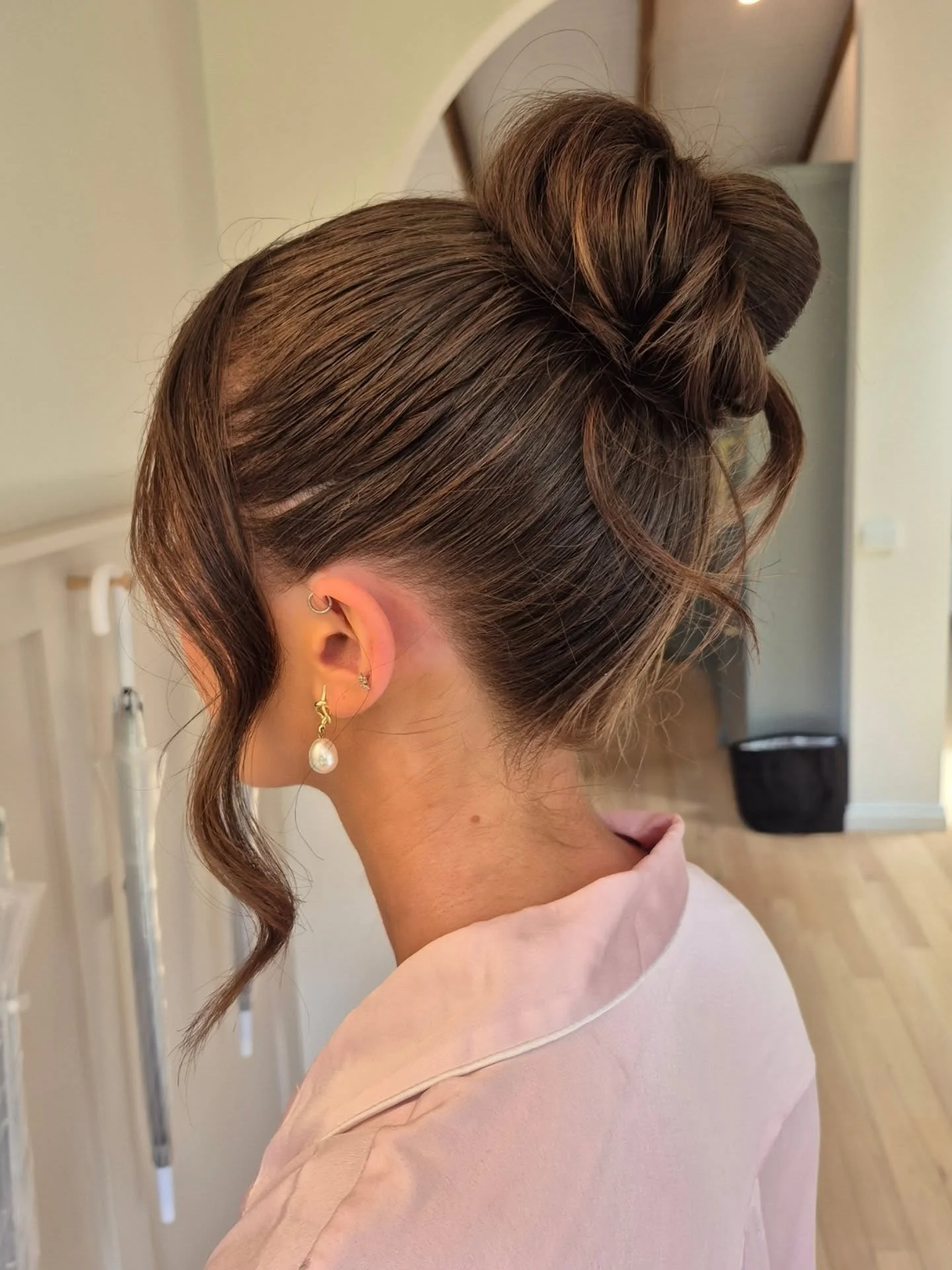 Fall hairstyles for wedding guests 2026 Modern High Bun with Soft Romantic Volume