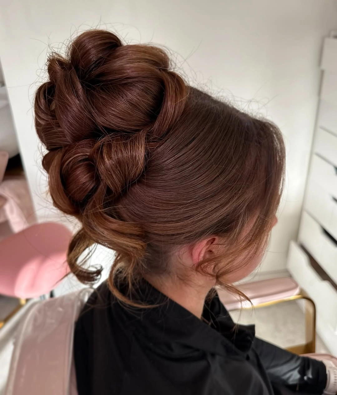 Fall hairstyles for wedding guests 2026 Modern Sculptural Updo with Soft Face-Framing Pieces