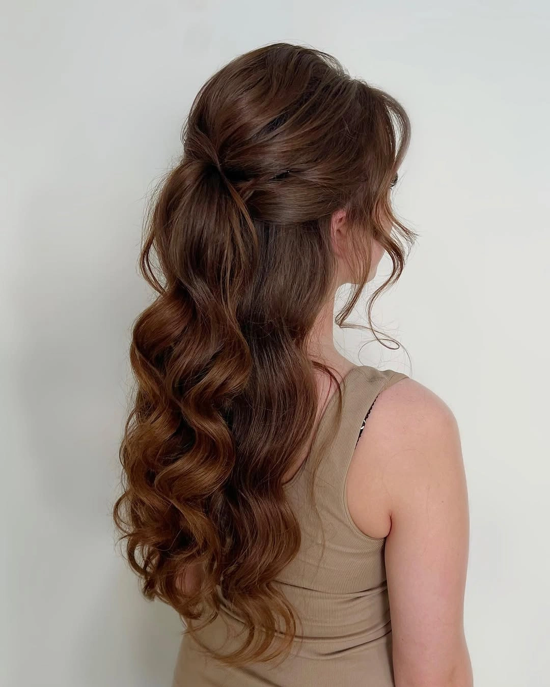 Fall hairstyles for wedding guests 2026 Relaxed Low Ponytail with Romantic Waves
