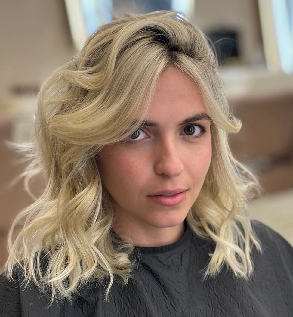 fall medium haircuts 2026 Voluminous Feathered Blonde with Curtain Bangs