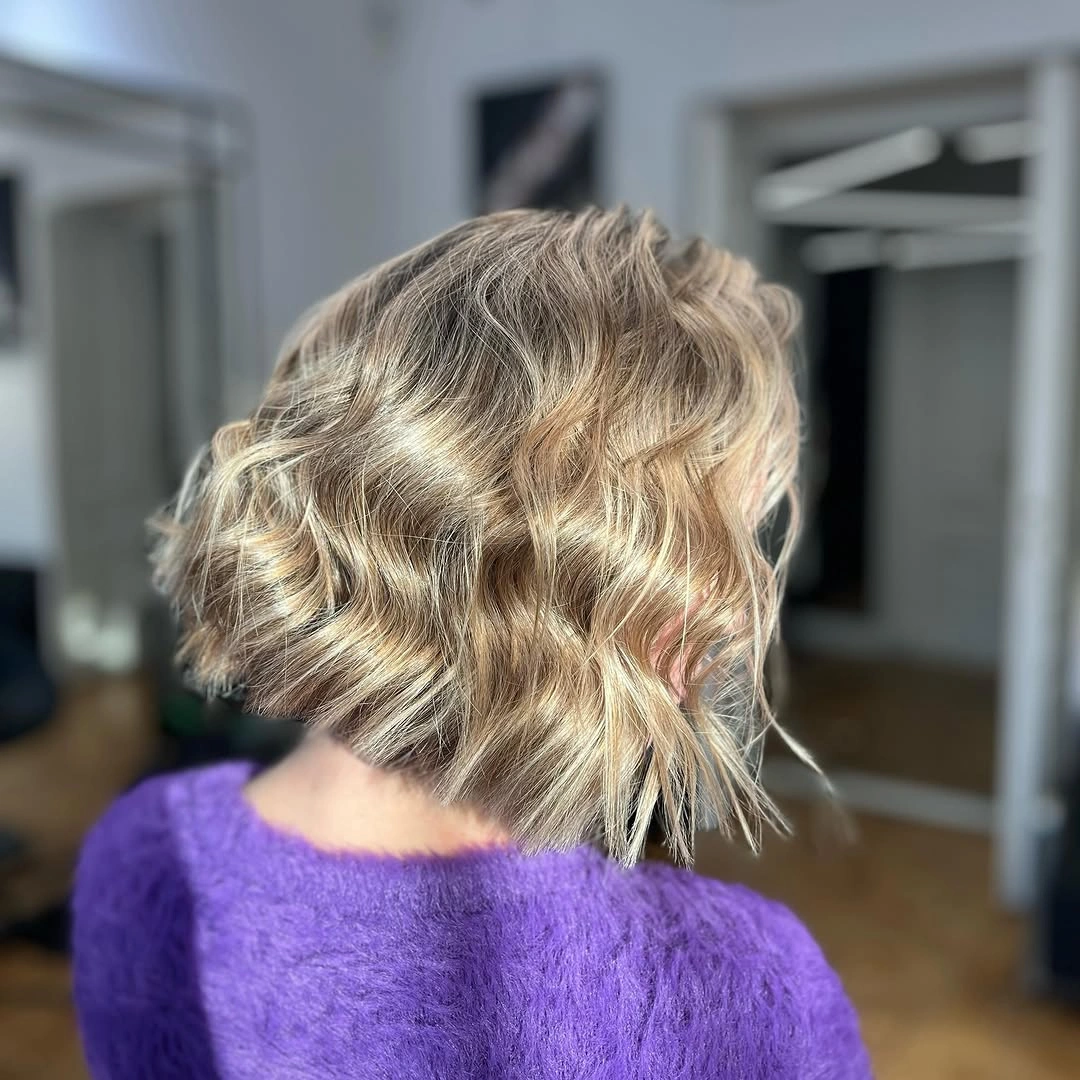 fall medium haircuts 2026 Textured Wavy French Bob with Soft Blonde Dimension