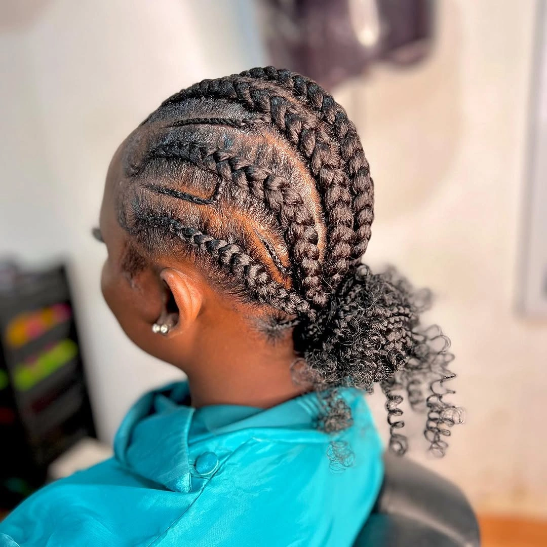 feed in braid hairstyles Curved Feed-In Braids Gathered Into A Textured Low Puff