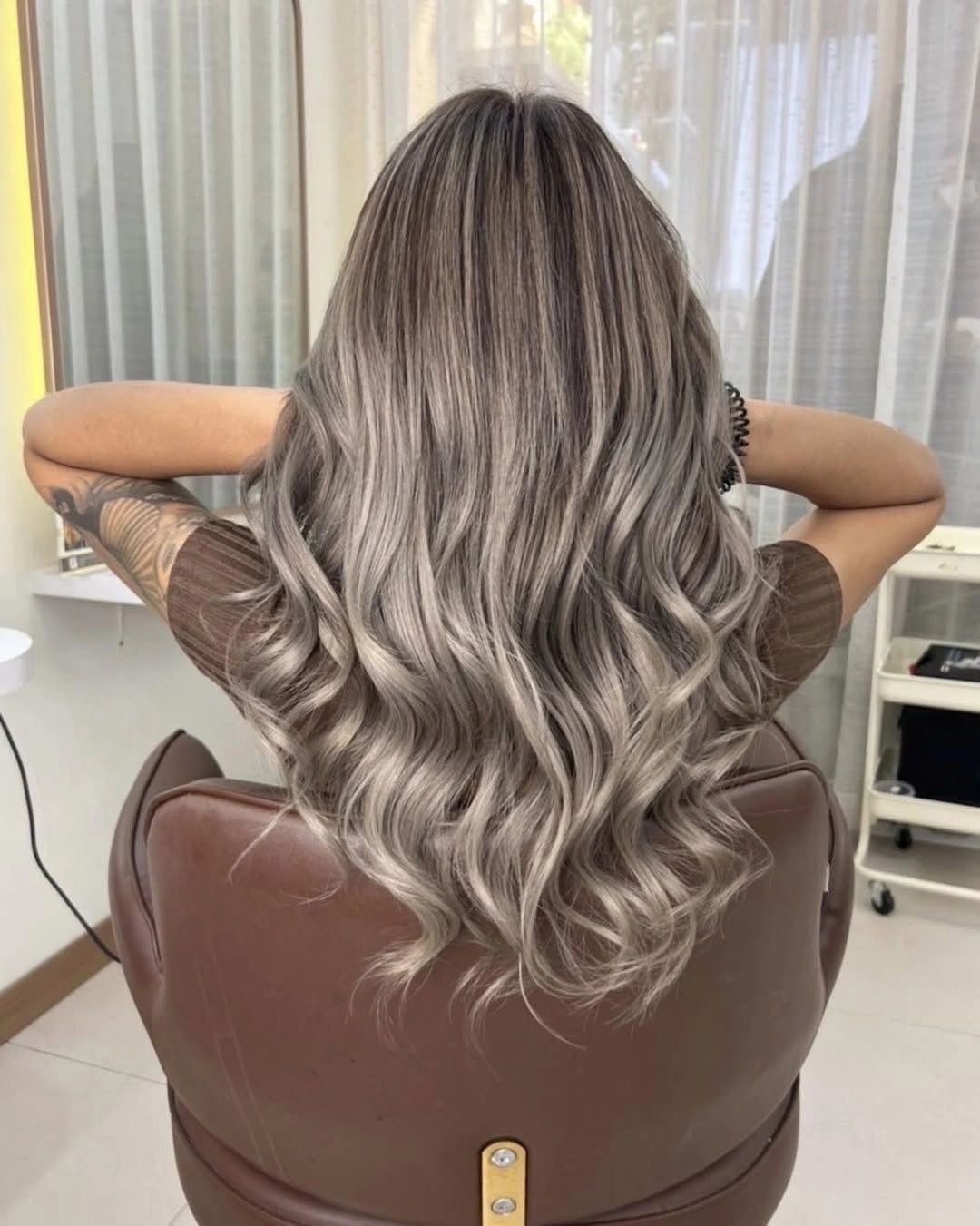 hair lowlights color ideas and inspiration Cool Blonde Waves With Smoky Beige Dimension